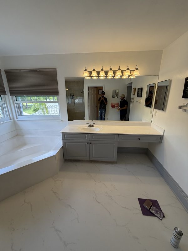 Master bathroom after painting, with grey vanity cabinetry and white walls